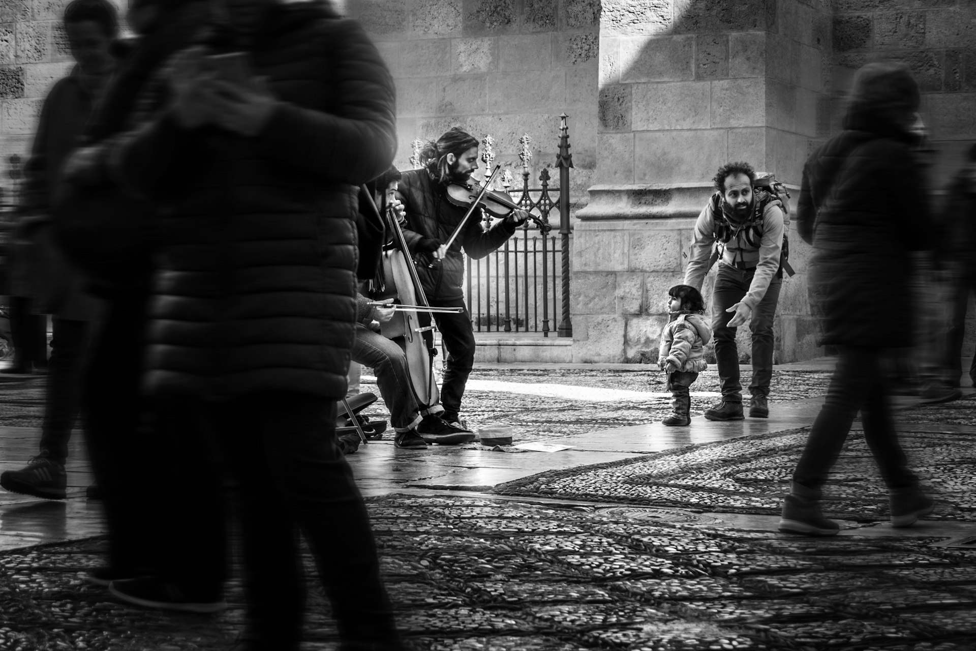 grayscale girl watching men playing instruments